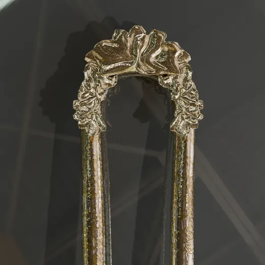 A gold hair pin with a textured head, rendered for iPackage